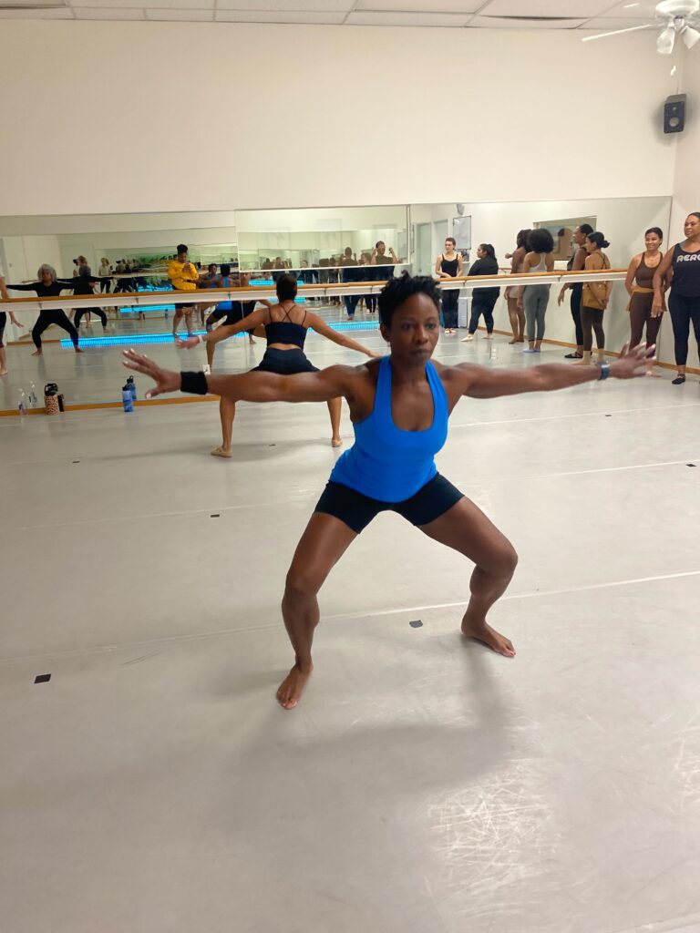 Woman practicing modern dance in an adult dance class in Dallas with other modern dance students